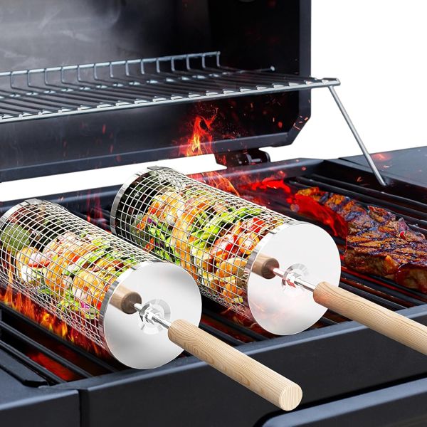 Two Ivtivfu stainless steel rolling grill baskets filled with vegetables on a grill